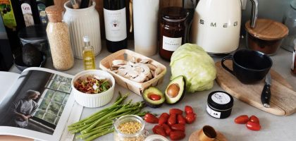 A variety of fresh ingredients and kitchen tools for preparing a healthy meal.
