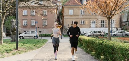 A couple jogging together in an urban park, enjoying outdoor exercise.
