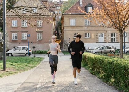 A couple jogging together in an urban park, enjoying outdoor exercise.